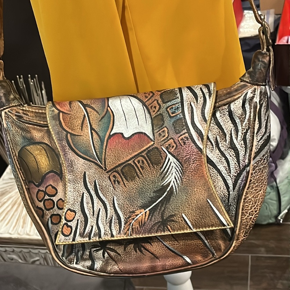 Sova Hand-painted Leather Crossbody. Never  used. Earth tone with silver accent